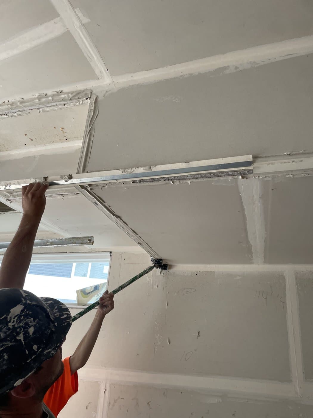 Killen Interiors tradesman taping drywall on an Edmonton job site